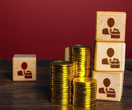 blokjes met symbool voor persoenen en stapeltjes muntstukken